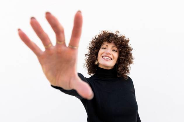 Creative Highlights Symbolfotos Fashionable woman reaching out hand in black clothing against a white background model released, Symbolfoto, LMCF02155