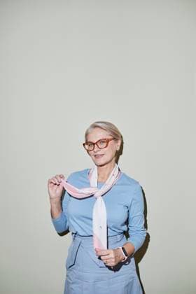 Creative Highlights Symbolfotos Portrait of an elegant businesswoman with glasses and a scarf against a neutral background model released, Symbolfoto, KPEF00953
