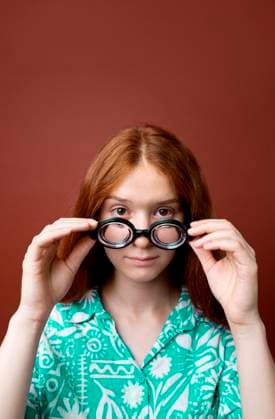 Creative Highlights Symbolfotos Teenage girl with red hair wearing funny glasses in a studio model released, Symbolfoto, VRAF01135