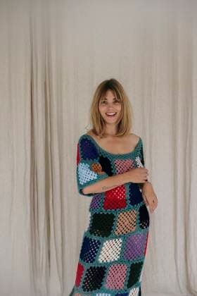 Creative Highlights Symbolfotos woman in colorful crochet dress dancing by beige curtains Amsterdam, North Holland, Netherlands CR_RTBZ250321-1687216-01 ,model released, Symbolfoto