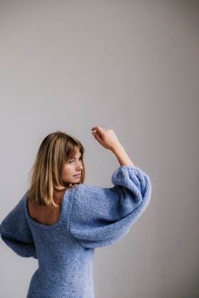 Creative Highlights Symbolfotos Woman in a soft blue knit sweater with a serene, contemplative look. Amsterdam, North Holland, Netherlands R_RTBZ250317-1679691-01 ,model released, Symbolfoto