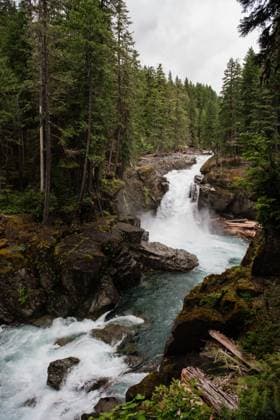 Creative Highlights World Mountain Waterfall Flowing into a Rocky River Rainier, Washington, United States R_FHOI250330-1687336-01
