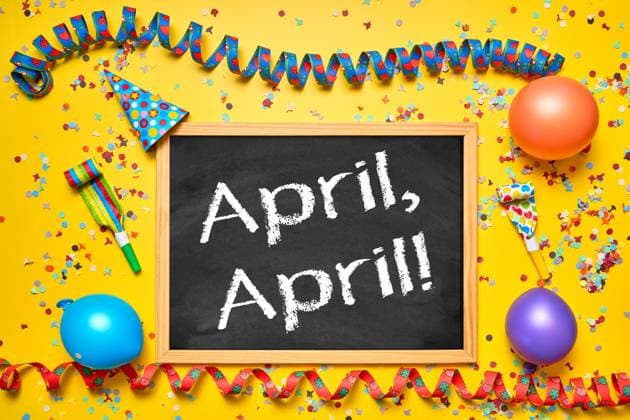 Germany - April 1, 2025: PHOTOMONTAGE, Colorful decoration with streamers, confetti and balloons around a board with the words: April, April! Symbolic image for the first of April and jokes *** FOTOMONTAGE, Bunte Dekoration mit Luftschlangen, Konfetti und Ballons rund um eine Tafel mit dem Schriftzug: April, April! Symbolbild für den ersten April und Scherze
