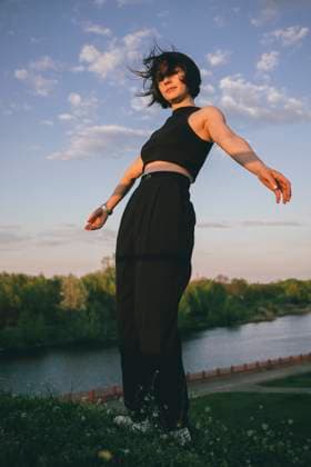 Creative Highlights Symbolfotos Stylish Woman in Black Outfit Posing Against a Sunset Sky Belarus, Brest Region, Kobryn R_ALLI25040185-1176408-01 ,model released, Symbolfoto