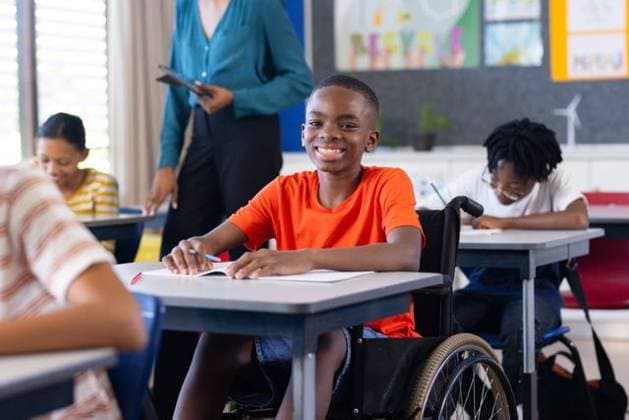 In school, boy in wheelchair smiling and writing at desk in classroom In school, boy in wheelchair smiling and writing at desk in classroom. Education, studying, learning, student, inclusion, accessibility, model released, , property released, Cape Town, South Africa, 18.05.2024, 5565506.jpg, people,boy,wheelchair,smiling,writing,desk,classroom,education,studying,learning,student,inclusion,accessibility,disability,back to school,adaptive,assistive,support,equality,empowerment,classroom environment,academic,unaltered,school,child,youth,engagement,participation,diversity,teamwork,motivation,inspiration,determination,achievement,focus,concentration,creativity,expression,interaction,peers,friendship,collaboration,resources,tools,curriculum,dev