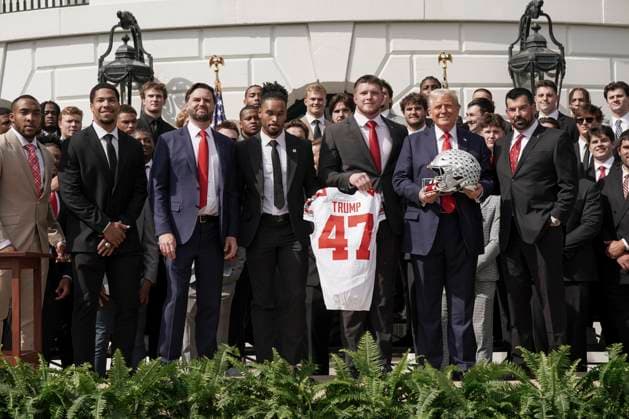 President Trump holds a helmet gifted to him by the 2025 College Football National Champions - The Ohio State University on the South Lawn of the White House in Washington, DC on Monday, April 14, 2025.  WAS20250414573 KenxCedeno