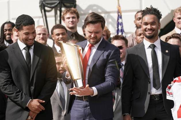 Vice President JD Vance holds the top of the team trophy after he dropped the base while the 2025 College Football National Champions - The Ohio State University visited on the South Lawn of the White House in Washington, DC on Monday, April 14, 2025.  WAS20250414582 KenxCedeno