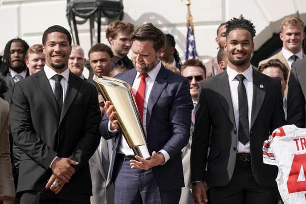 Vice President JD Vance holds the top of the team trophy after he dropped the base while the 2025 College Football National Champions - The Ohio State University visited on the South Lawn of the White House in Washington, DC on Monday, April 14, 2025.  WAS20250414585 KenxCedeno