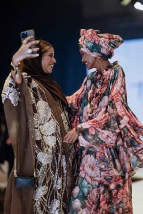 April 15, 2025, Abu Dhabi, United Arab Emirates: Somali model Halima Aden seen greetings a guest. Turkish brand Imannor presented at the final show of the second day of Abu Dhabi Modest Fashion Week 2025 (14-16 April), organized by Think Fashion at St. Regis Saadiyat Island Resort. Abu Dhabi United Arab Emirates - ZUMAs197 20250415_aaa_s197_605 Copyright: xValeriaxFerrarox