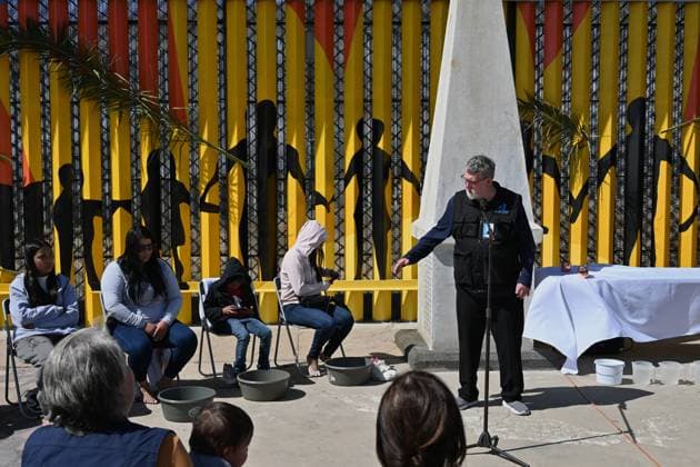 April 17, 2025, Tijuana, Baja California, Mexico: Father Pat Murphy from La Casa del Migrante in Tijuana, Mexico gives a sermon during a ceremony for holy week in accordance to the twelve apostles remembrance of Jesus Christ Ã¢â‚¬oeFor I have given you an example, that you should do as I have done to youÃ¢â‚¬Â as Father Murphy compares Jesus act to migrants plight and the unfair treatment of migrants and urged for a time of reflection for those seeking the right to freedom of movement and humanitarian asylum, during the shelterÃ¢â‚¬â ¢s annual foot washing ceremony on Thursday, April 17, 2025 at TijuanaÃ¢â‚¬â ¢s Friendship Park circle on the US-Mexico border. Tijuana Mexico - ZUMAm180 20250417_zip_m180_011 Copyright: xCarlosxA.xMorenox
