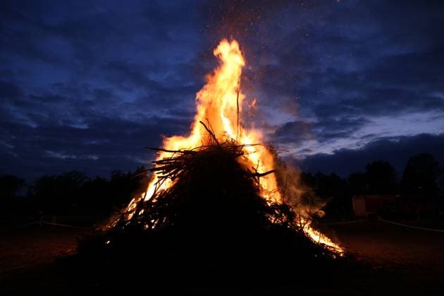 April 19, 2025, Cottbus, Brandenburg, Germany: The Easter fire is burning at Branitzer Park in Cottbus, eastern Germany. Easter fires, or Paschal fires, are bonfires lit on Holy Saturday, especially in Northern Germany and the Netherlands, rooted in pre-Christian spring rituals and later adopted by Christian Easter traditions. They symbolize light overcoming darkness and ChristÃ¢â‚¬â ¢s resurrection. The custom is celebrated with community gatherings, and in churches, the fire is used to light the Paschal candle at the start of the Easter Vigil. Variations of the tradition exist in other countries with local meanings. Cottbus Germany - ZUMAf146 20250419_zip_f146_027 Copyright: xRouzbehxFouladix