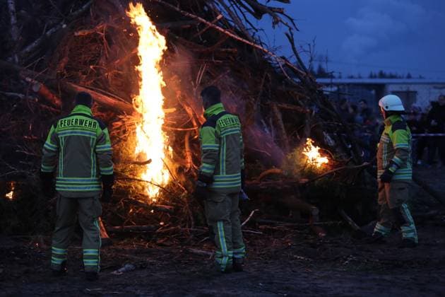 April 19, 2025, Cottbus, Brandenburg, Germany: The firefighters are lighting the Easter fire at Branitzer Park in Cottbus, eastern Germany. Easter fires, or Paschal fires, are bonfires lit on Holy Saturday, especially in Northern Germany and the Netherlands, rooted in pre-Christian spring rituals and later adopted by Christian Easter traditions. They symbolize light overcoming darkness and ChristÃ¢â‚¬â ¢s resurrection. The custom is celebrated with community gatherings, and in churches, the fire is used to light the Paschal candle at the start of the Easter Vigil. Variations of the tradition exist in other countries with local meanings. Cottbus Germany - ZUMAf146 20250419_zip_f146_017 Copyright: xRouzbehxFouladix