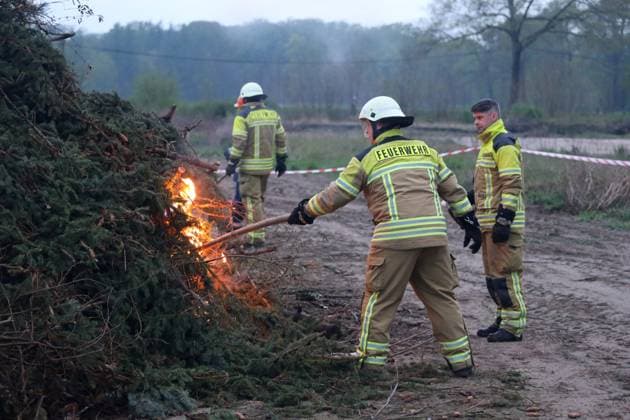 April 19, 2025, Cottbus, Brandenburg, Germany: The firefighters are lighting the Easter fire at Branitzer Park in Cottbus, eastern Germany. Easter fires, or Paschal fires, are bonfires lit on Holy Saturday, especially in Northern Germany and the Netherlands, rooted in pre-Christian spring rituals and later adopted by Christian Easter traditions. They symbolize light overcoming darkness and ChristÃ¢â‚¬â ¢s resurrection. The custom is celebrated with community gatherings, and in churches, the fire is used to light the Paschal candle at the start of the Easter Vigil. Variations of the tradition exist in other countries with local meanings. Cottbus Germany - ZUMAf146 20250419_zip_f146_019 Copyright: xRouzbehxFouladix