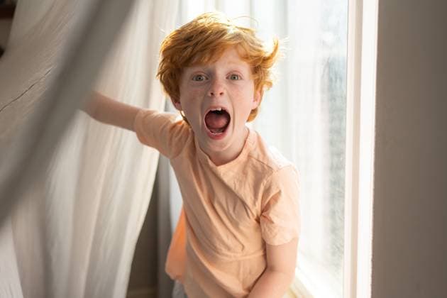 Creative Highlights Symbolfotos Young red head boy makes silly face in front of window at home Grimes, Iowa, United States CR_LIPF250419-1702574-01 ,model released, Symbolfoto