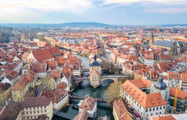 (250423) -- FRANKFURT, April 23, 2025 -- An aerial drone photo taken on March 24, 2025 shows the ancient town of Bamberg, in Bavarian state, Germany. Bamberg in Germany and Shexian in China show how towns with a remarkable history can thrive today. They answered the 2025 World Heritage Day call to protect heritage under threat from disasters and conflicts, blending conservation with daily life. TO GO WITH Feature: Ancient towns in Germany, China join forces to protect heritage ) LensToLens Ancient towns in Germany, China join forces to protect heritage MaxZhiyi 