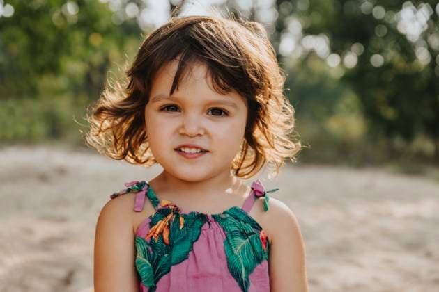 Creative Highlights Symbolfotos Smiling cute little girl standing at beach on sunny day model released, Symbolfoto, MFF06225