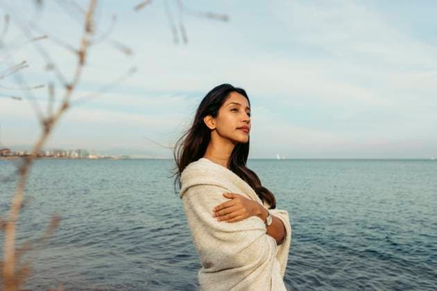 Creative Highlights Symbolfotos Contemplating woman with arms crossed against sky at beach model released, Symbolfoto, VABF04173