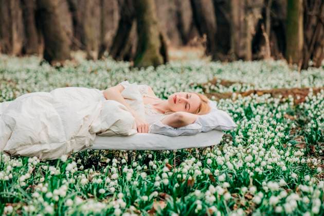 Creative Highlights Symbolfotos Woman waking up in a forest meadow surrounded by lilies of the valley model released, Symbolfoto, VSNF03000