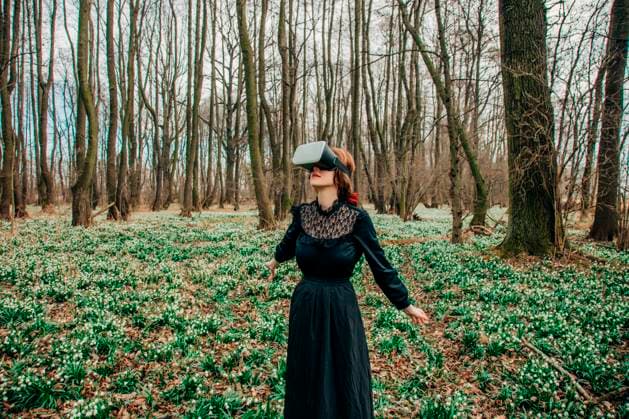 Creative Highlights Symbolfotos Woman in a vintage dress exploring virtual reality in a forest meadow with lilies of the valley model released, Symbolfoto, VSNF03006