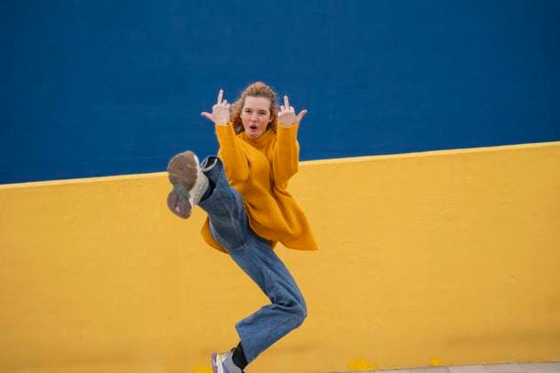 Creative Highlights Symbolfotos Blonde woman in casual fashion striking a playful pose against a colorful urban backdrop model released, Symbolfoto, JCCMF13215