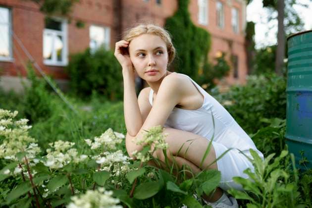 Creative Highlights Symbolfotos Girl in a white dress sitting in a garden near a house during a summer evening model released, Symbolfoto, VCF00655