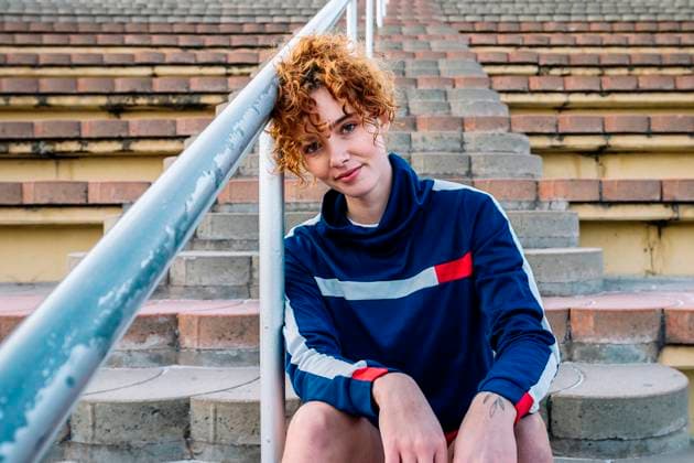 Creative Highlights Symbolfotos Athlete resting on stadium steps outdoors model released, Symbolfoto, GDBF00192