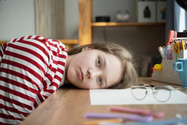 Creative Highlights Symbolfotos Tired teenage girl lying on desk model released, Symbolfoto property released, LESF00681
