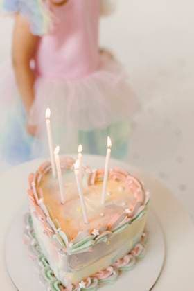 Girl in a tutu dress celebrating with a heart-shaped birthday cake indoors model released, Symbolfoto property released, VIVF01638