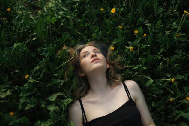 Creative Highlights Symbolfotos Girl lying among dandelions in a meadow looking up model released, Symbolfoto, VCF00676