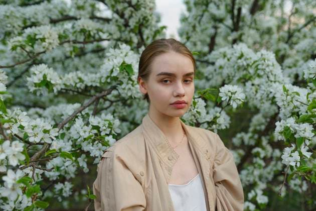 Creative Highlights Symbolfotos Young woman standing by a blossoming apple tree outdoors model released, Symbolfoto, VCF00682