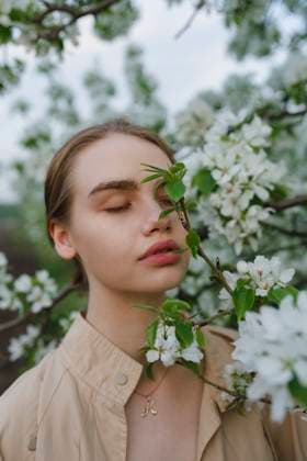 Creative Highlights Symbolfotos Young woman with closed eyes standing by a blossoming apple tree outdoors model released, Symbolfoto, VCF00684