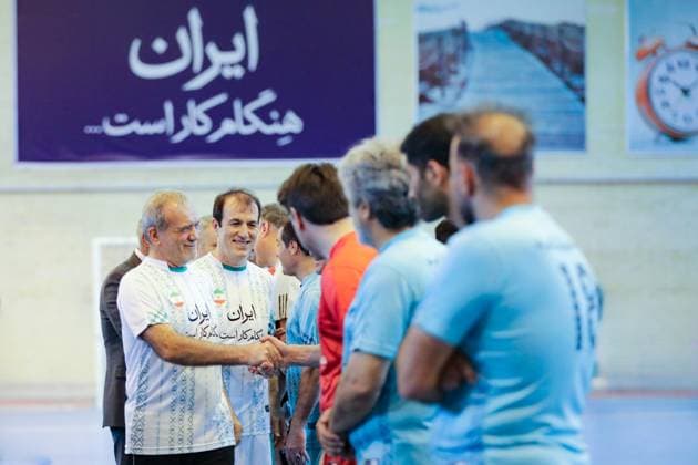 April 25, 2025, Tehran, Iran: Iranian President MASOUD PEZESHKIAN (L) participates in a football match to celebrate Iran Labor Week and honor the laborers of the nation, competing between the workers and veterans teams. Tehran Iran - ZUMAi98_ 20250425_zih_i98_018 Copyright: xIranianxPresidencyx