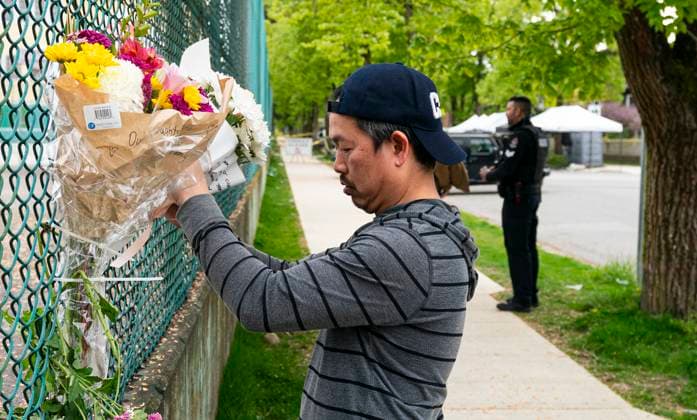April 27, 2025, Vancouver, Bc, CANADA: A man leaves flowers on a fence, near the location where a vehicle drove into crowd at a street festival last night, in Vancouver, Sunday April 27, 2025. Members of the community are sharing their shock and devastation in the wake of a car-ramming attack at a Vancouver street festival that left 11 people dead and dozens more injured. Vancouver CANADA  - ZUMAc35_ 20250427_zaf_c35_026 Copyright: xRichxLamx