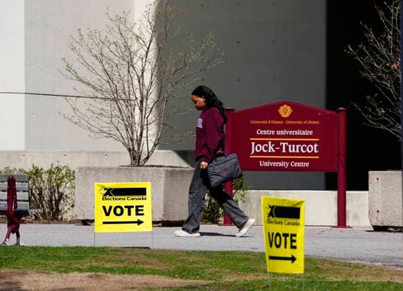 April 28, 2025, Ottawa, On, CANADA: A person walks past vote signs indicating a polling station at the University of Ottawa, on the day of the federal election, in Ottawa, on Monday, April 28, 2025. Ottawa CANADA  - ZUMAc35_ 20250428_zaf_c35_006 Copyright: xJustinxTangx
