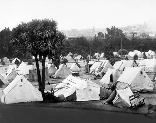 April 20, 1906, San Francisco, California, USA: Refugee camp established after earthquake in Jefferson Park in vicinity of Eddy and Gough Streets; the large church tower shown on right is Sacred Heart Church, Fillmore and Fulton Streets, San Francisco, California, USA, U.S. Army Signal Corps, 1906 San Francisco USA  - ZUMAg145 19060420_aza_g145_002 Copyright: xJTxVintagex