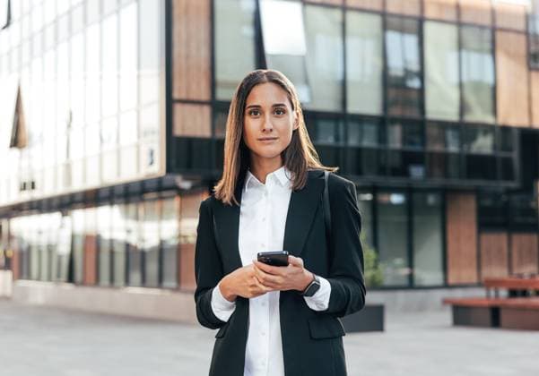 Creative Highlights Symbolfotos Portrait of a young woman in formal wear standing outside against an office building Portrait of a young woman in formal wear standing outside against an office building Copyright: xArtemxVarnitsinxArtemxVarnitsinx