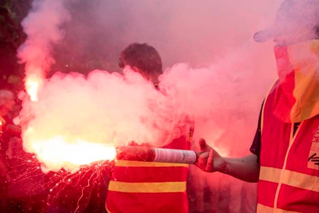 May 1, 2025, Paris, France: A protester holds a red flare during the march of the International Workers Day in Paris. Hundreds of thousands marched through on central Paris, France on the International Workers Day May Day from Place d Italie to Place de la Nation. Paris France - ZUMAs197 20250501_aaa_s197_345 Copyright: xKrisztianxElekx