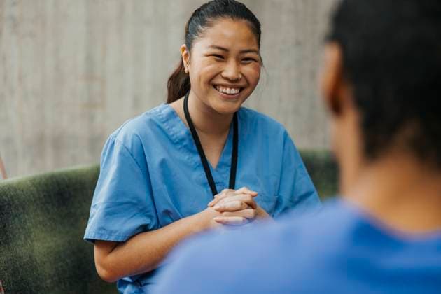 IMAGO Creative, Diversity, Pflege im Krankenhaus Happy young female medical professional with hands clasped talking with colleague in clinic Sweden, Gothenburg, model released, property released Copyright: xMaskotx , MA117359 MA117359