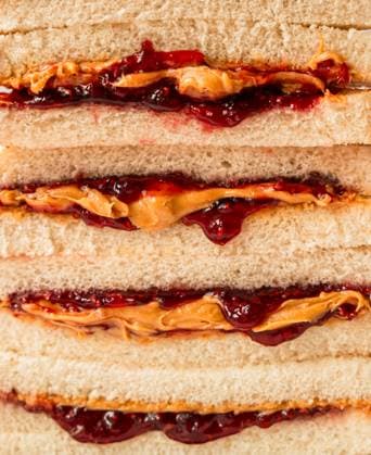 Close up of stack of peanut butter and jam sandwiches on white bread. Kingston, Ontario, Canada CR_DOHO250508B-1721399-01