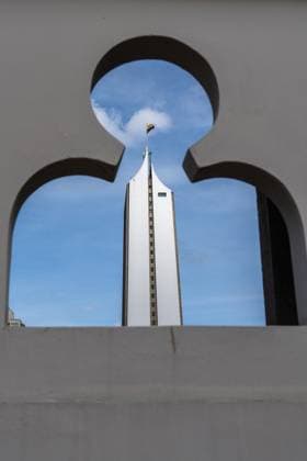 Creative Highlights World The Coltejer Building, the tallest building in Medellin, Colombia, framed by a design on the Palace of Culture. Medellin Antioquia Department Colombia Copyright: xJonxG.xFullerx xVWPicsx 8608-JGF-cityscapes-Medellin-CO