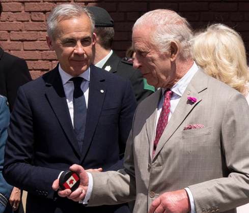 May 26, 2025, Ottawa, On, CANADA: Prime Minister Mark Carney looks on as King Charles holds on to his puck following a ceremonial puck drop during a visit to Lansdowne Park in Ottawa on Monday, May 26, 2025. Ottawa CANADA  - ZUMAc35_ 20250526_zaf_c35_077 Copyright: xChristinnexMuschix