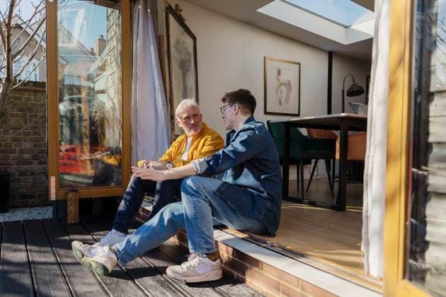 Father and son having a conversation on the patio of their home model released, Symbolfoto property released, ASGF06538