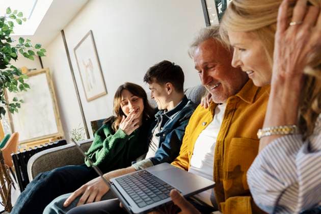 Family enjoying time together in the living room with a laptop model released, Symbolfoto property released, ASGF06580