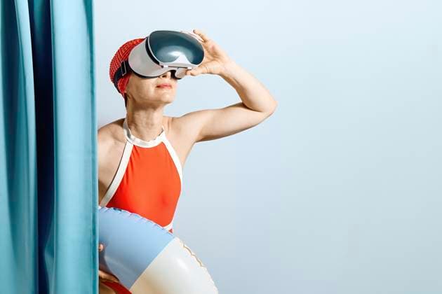 Creative Highlights Symbolbilder Woman in red swimsuit with VR headset and swimming ring indoors model released, Symbolfoto, CATF00640
