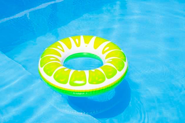 Colorful inflatable pool float in a sunny swimming pool property released, FLMF01412