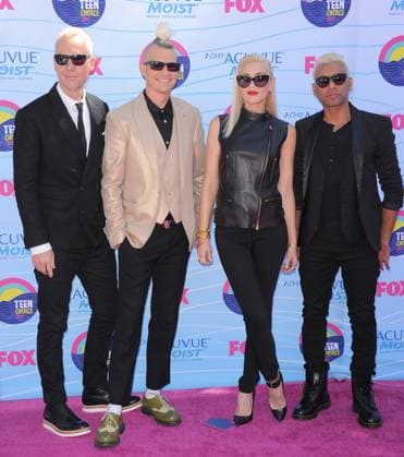2012 Teen Choice Awards - Arrivals Tom Dumont, Adrian Young, Gwen Stefani & Tony Kanal of No Doubt FOX s 2012 Teen Choice Awards held at The Gibson Ampitheatre in Universal City, California, USA. July 22nd, 2012 full length black leather sunglasses shades red lipstick sleeveless zip zipper top trousers beige band group suit CAP DVS DVS Universal City California United States Copyright: xDVS CapitalxPicturesx