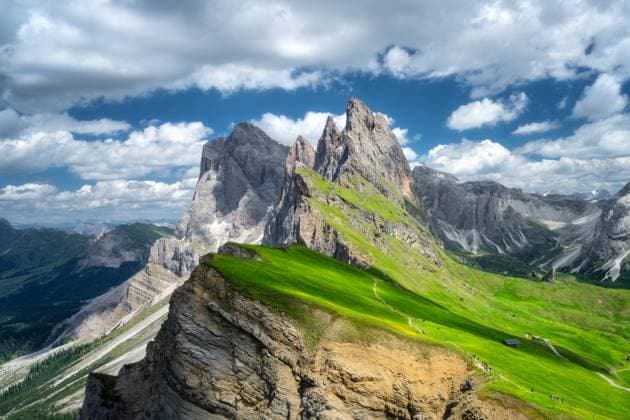 Aerial view of Seceda mountain in summer in Dolomites, Italy. Colorful landscape with mountain peaks, rocks, alpine meadows, trail, green grass, blue sky with clouds. Nature. Top view of Alps Model Released DenisBilytskyi_ID26964_778296_017 Copyright: xDenisxBilytskyix