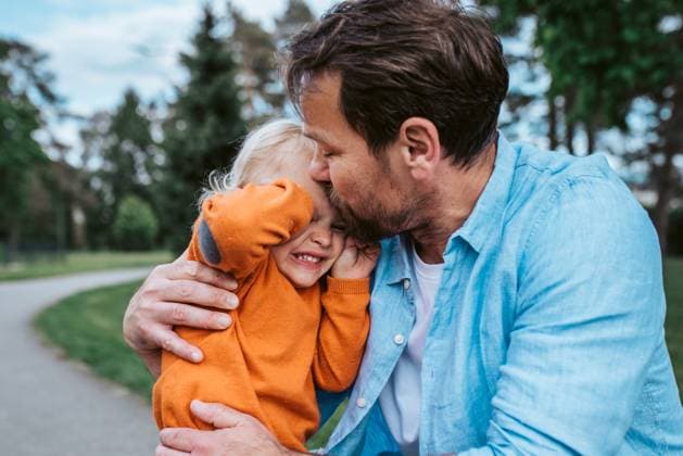 Father comforting young son during emotional moment in park Father comforting young son during his emotional moment in park model released
