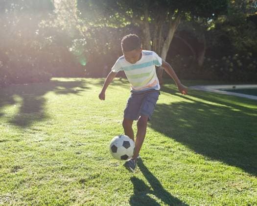 Boy dribbling black-and-white soccer ball across yard near pool under bright sunlight, lens flare Boy dribbling black-and-white soccer ball across yard near pool under bright sunlight, lens flare. Play, outdoor, vibrant, childhood, activity, relaxation, recreational, model released, , property released, , 12.05.2021, 5850575.jpg, soccer ball,dribbling,boy,outdoor,play,childhood,activity,relaxation,recreational,sunny,sunlight,lens flare,yard,grass,lawn,trees,shrubs,pool,african american,male,child,striped t-shirt,cargo shorts,sneakers,athletic,vibrant,green,foliage,summer,bright,sportive,movement,energy,healthy,youth,field,game,garden,natural,sunlit,casual,leisure,dynamic,active,happiness,single,grassland,sport,exercise