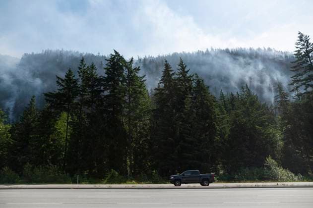 June 11, 2025, Squamish, B.C, CANADA: A vehicle drives past the Dryden Creek Wildfire, just north of Squamish, B.C., on Wednesday, June 11, 2025. Squamish CANADA  - ZUMAc35_ 20250611_zaf_c35_067 Copyright: xTijanaxMartinx
